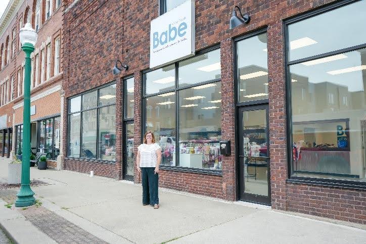 Laura Tucker, Executive Director, poses in front of new BABE of Whitley County downtown Columbia City location